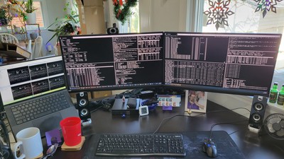 The very first version - just a cheap, old Linux box and six VMs running on it. The large screens are terminals open to the different boxes while the far left screen of the laptop are VNC sessions open to all six consoles of the running VMs.