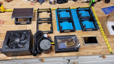 With the holsters printed up and the power supply in hand, it's time to start bench fitting the parts to see how much space we actually have to work with. Notice the cardboard cutouts used as placeholders - whatever works works!
