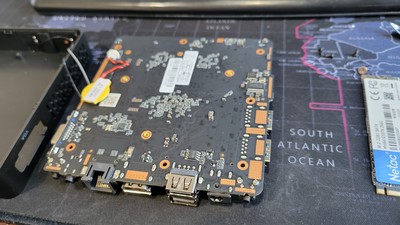 Tutorial - How to solder on a remote power button relay - the bottom view of the motherboard. Looking at this picture, the two pins to bridge to simulate a button press are in the bottom right corner.