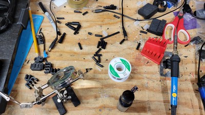 More post-wiring havoc. Most of the sheaths seen in the photo came from Cat6 cable used to provide network to all the devces. After each major milestone I airdust and brush off the workbench. Give it a few more hours of work and it's right back to looking like this.